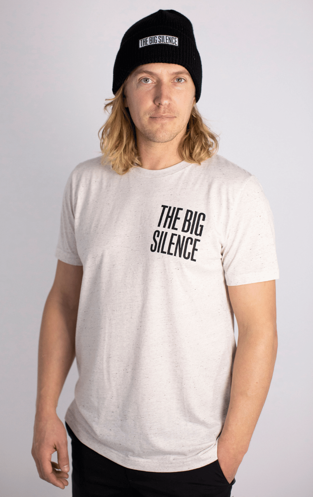 Bobby wearing square logo tee and black beanie with black jeans and hand in pocket