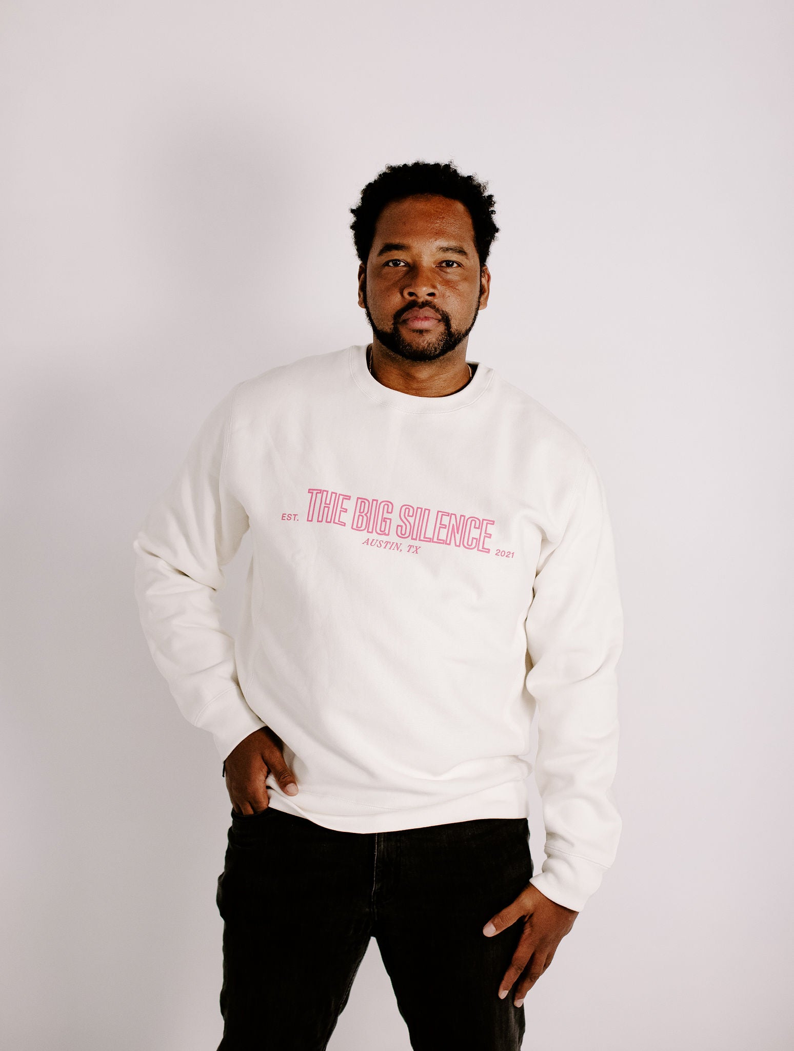 James in bone sweatshirt and jeans