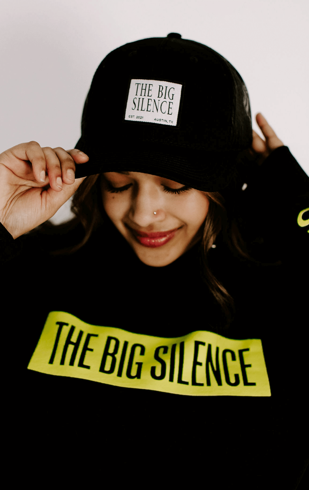 Anuja in trucker hat and pullover hoodie