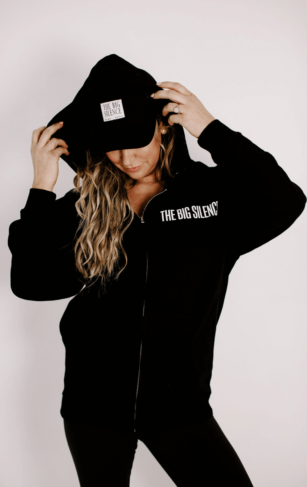 Karena in TBS hoodie with trucker hat and jeans